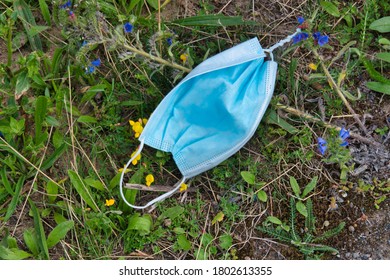 A Used, Blue Surgical Mask Used For COVID-19 PPE Protection, Discarded As Litter In Rural Countryside