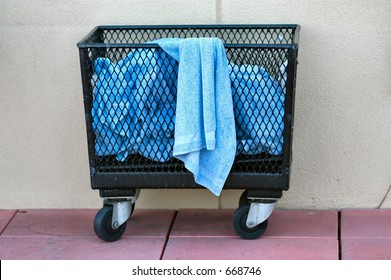 Used blue terry cloth towels in a wire basket
