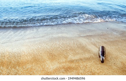 Used Bottle On Sea Beach In Pollution And Bad Environtment From Human Behavior Concept 