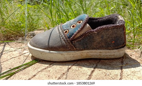 Used Boy Shoes On The Side Of The Road Next Door