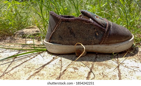 Used Boy Shoes On The Side Of The Road Next Door