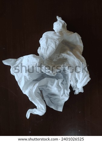 USED ​​TISSUE WITH BROWN BACKGROUND