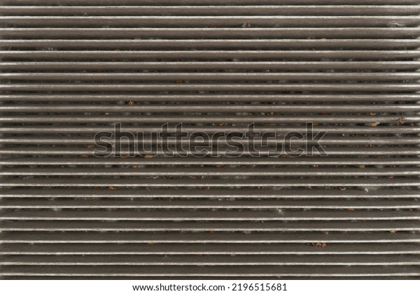 Used car cabin charcoal air\
filter texture background. Dirty carbon car air filter with dust\
pattern.