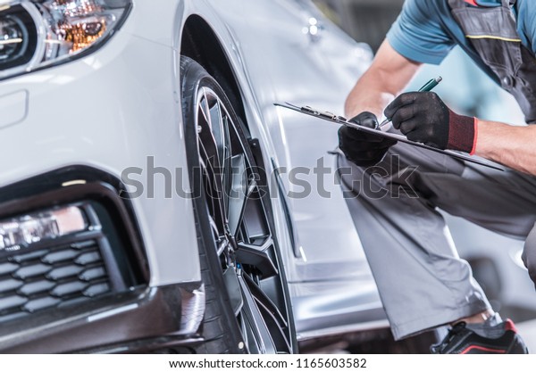 Used Car Maintenance. Auto Service\
Worker Preparing Vehicle For Scheduled\
Service.