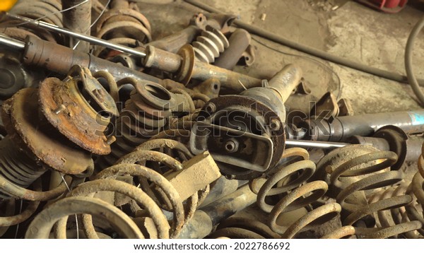 Used car parts on the factory shelf. Used auto\
parts for sale in a store in a landfill. Springs and shock\
absorbers of the passenger car suspension. Disassembly of cars. A\
used auto parts store.