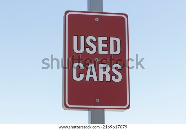 Used car sign at a\
pre-owned auto dealership. With supply issues, used and preowned\
cars are in high demand.