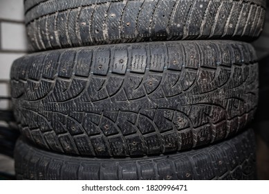 Used car tires against a brick wall. Worn tread of winter tires - Powered by Shutterstock