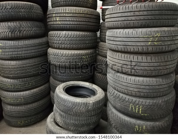 Used car tires, stacked on top of each other. \
Seasonal  tire change.