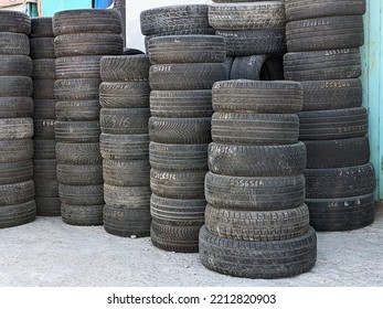 Used Car Tires Stacked In Rows In The Yard Of A Tire Repair Workshop