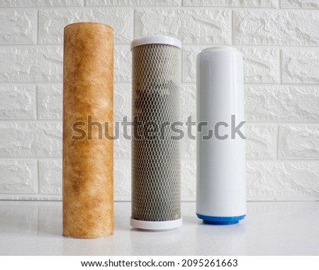 Used cartridges for water purification. Three cartridges for a household reverse osmosis system for water purification from mechanical impurities, chlorine and inorganic impurities