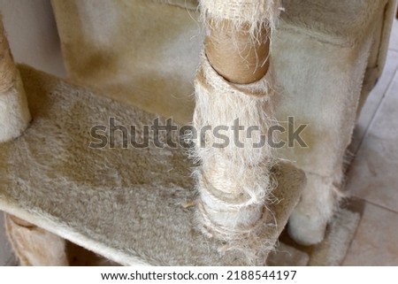 Used cat scratching post.  Old cat tower with copy space on the left side. 