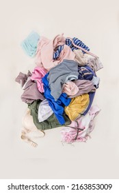 Used clothes in a pile. Sorting second-hand for recycling. Copy space on white background. Top view