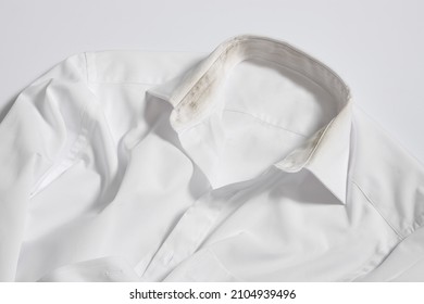 used collar dirty white shirt is ready to be washed - Shutterstock ID 2104939496
