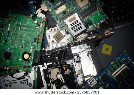 Used computer and laptop parts for e-waste recycling. Large colored heap of electronic, plastic and metal refuse from old discarded or obsolete PC components. Ecological danger.