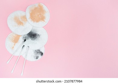 Used Cotton Pads And Cotton Swabs. Used Cosmetic Pad After Removing Make-up. Pink Background. Place For Text. Copy Space. Flat Lay. Dirty