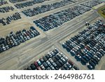 Used damaged cars on auction reseller company big parking lot ready for resale services. Sales of secondhand vehicles for rebuilt or salvage title