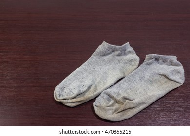 Used Dirty Socks On Wooden Floor