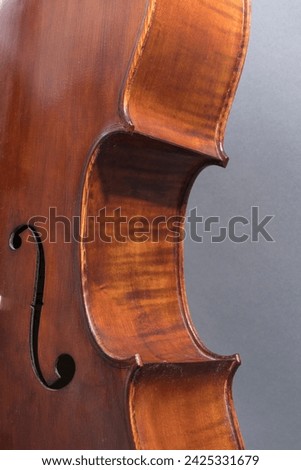 Used and dusty cello, detail, soundhole and curve.