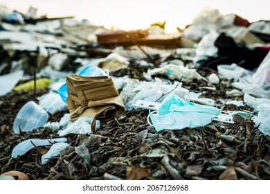 Used face mask discard in household garbage. Medical waste disposal with unhygienic management. Contaminated waste in community. Disposable earloop face mask waste garbage on floor. Coronavirus impact - Shutterstock ID 2067126968