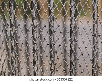 Used Fishing Fish Net Made Of Grey Black Rope Hanging To Dry In A Shrimp Farm In Thailand