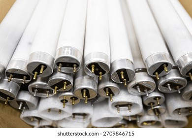 Used fluorescent lamp bases in a stack.
