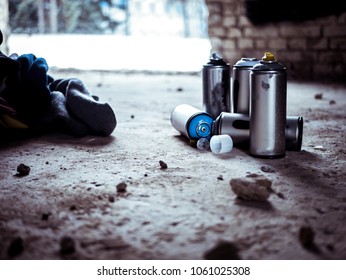 Used Graffiti Spray Paint Cans On The Ground 