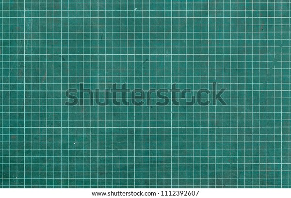 Used green cutting mat with printed grid line. Mat with\
non-slip and non reflective thick surface. Blade-resistant mat for\
crafting materials without damaging surfaces. Mat for precise jobs.\
