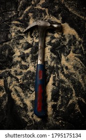 Used Hammer On Black Background With Saw Dust