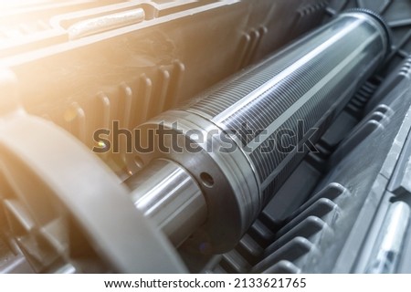 Used magnetic cylinder for rotary printing machine in plastic box. Magnetic shaft for die mounting. Selective focus Stockfoto © 