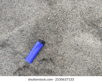 Used matches lighter on the sand that have been damaged are stranded - Powered by Shutterstock