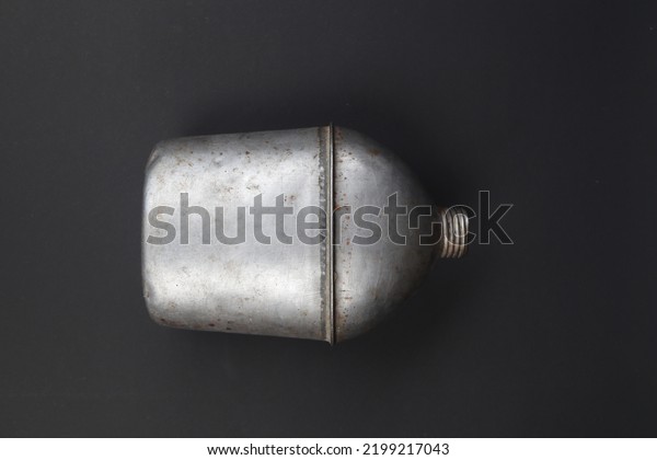 Used\
military drinking bottles or metal drinking bottles ex-allied\
forces during WW2 isolated on black\
background
