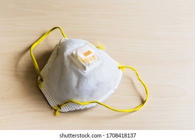 Used N95 Respiratory Mask With External One-way Valve Discarded On A Table; Concept For The Current PPE Shortage In The Battle Against COVID-19