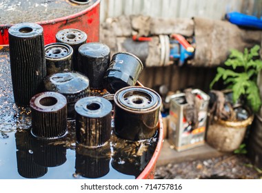 Used Oil Purification Filters On The Dirty Surface Of The Barrel With A Shallow Depth Of Field