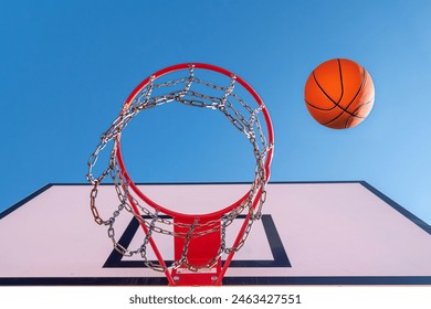 Used orange basketball with basket in background. Basketball street court stock photo