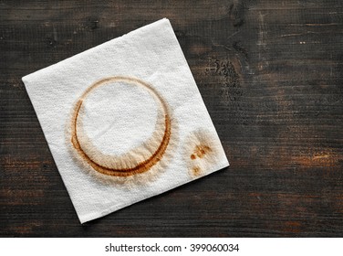 Used Paper Napkin With Coffee Stain On Dark Wooden Table, Top View