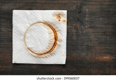 Used Paper Napkin With Coffee Stain On Dark Wooden Table, Top View