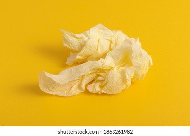 Used Paper Napkin On A Yellow Background.