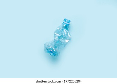 used plastic bottle on a blue background. The concept of using plastic. Environmental problem, global environment. Top view, flat lay. 