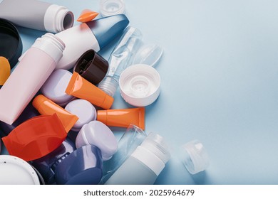 Used plastic packaging for cosmetics on a blue background. Trash with used cosmetics plastic packagings. High quality photo - Shutterstock ID 2025964679