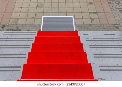 Used Red Carpet With Footsteps At Stone Stairs View Down