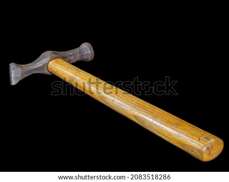 Used rusty hammer with wooden handle isolated on black background