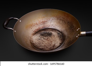 Used And Seasoned Wok With Black Background