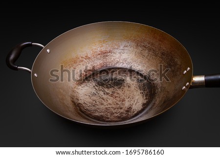 Used and seasoned wok with black background