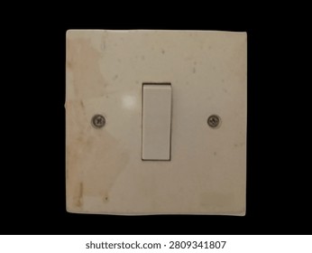 Used single electrical wall switch isolated on black background. Minimal home electricity control device with copy space for electrical installation, maintenance, home improvement, and safety concepts.