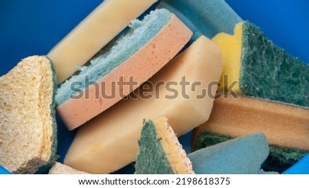 Used sponges in plastic basin