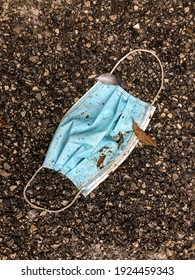 Used Surgical Face Mask Thrown Away On The Ground