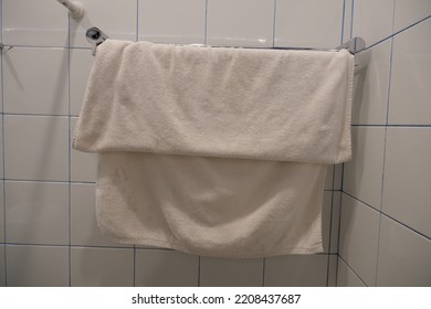 Used Towel Hanging In The Bathroom