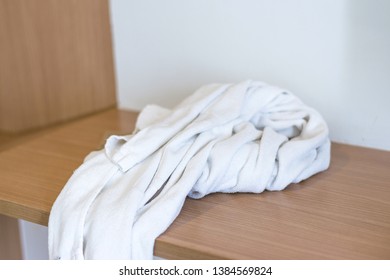 Used towels on the wood counter in bedroom of hotel