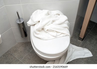 Used White Towel Lying On A Toilet At Hotel Bathroom