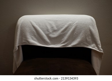 Used white towels to cover the chairs in the room.